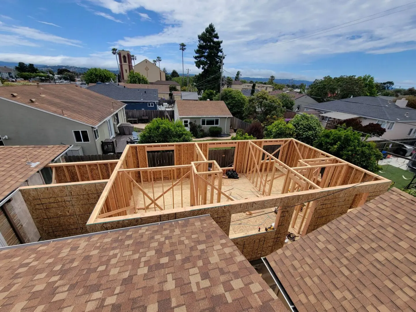 A house under construction with the roof being built.