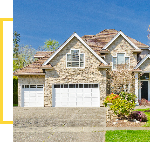 A house with two garage doors and a driveway.