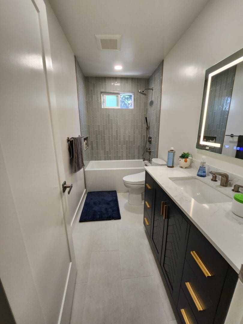 A bathroom with white walls and dark wood cabinets.